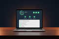Essential Website Care Plan by DD Network — laptop showing a website health dashboard with green uptime indicators and security checks